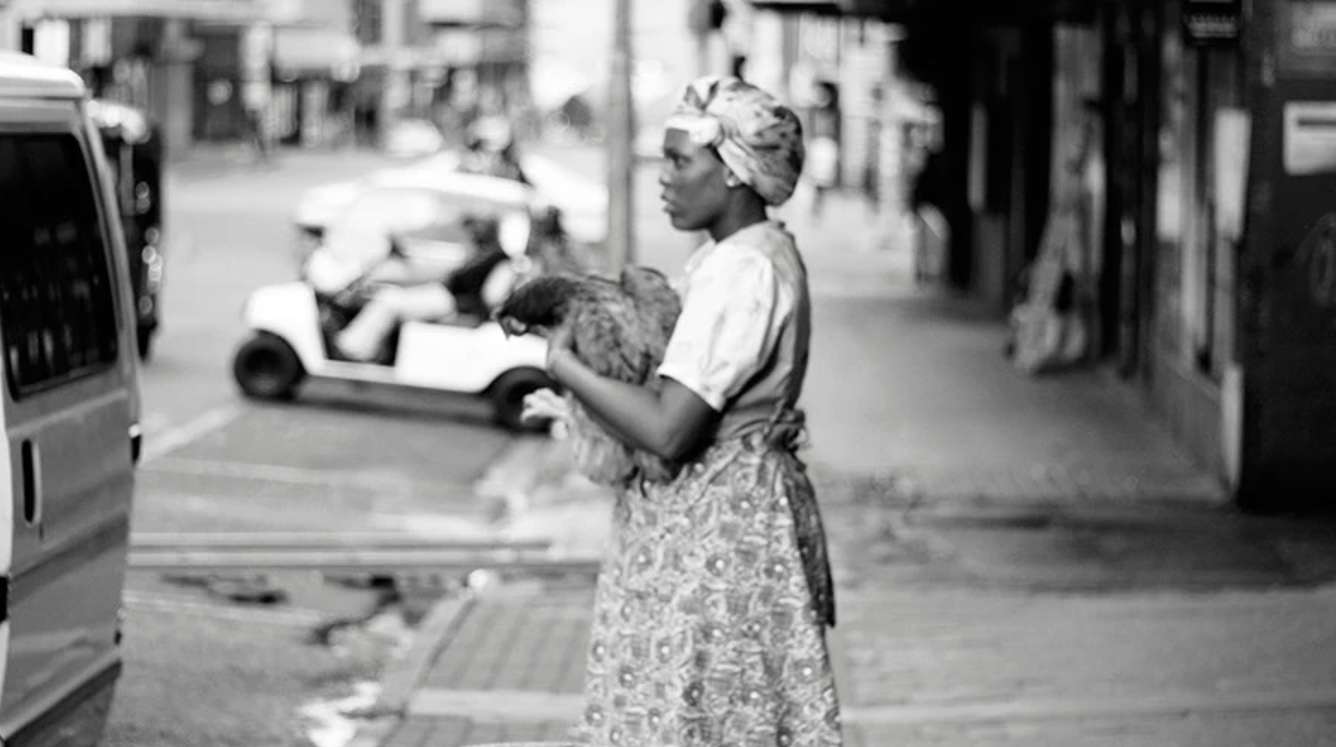 Woman holding a chicken
