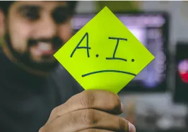 Man holding a sign that says AI