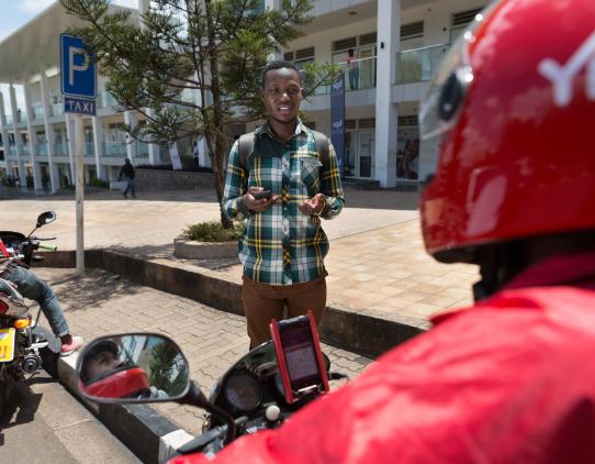 Man with a mobile phone talking with a person on a bike Man with a mobile phone talking with a person on a bike