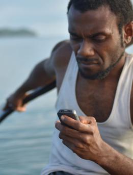 Man using a mobile phone on a boat Man using a mobile phone on a boat